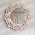 Macrame mirror on a white wall. The mirror reflects macrame wallhanging. Eco-style. Natural materials. Soft fokus