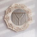 Macrame mirror on a white wall.  The mirror reflects macrame wallhanging. Eco-style. Natural materials. Soft fokus Royalty Free Stock Photo