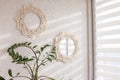 Macrame mirror and wreath on a white wall. Eco-style. Natural materials