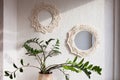 Macrame mirror and wreath on a white wall. Eco-style. Natural materials