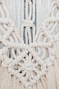 Macrame tapestry up close. Knots, ropes and tassels arranged in a pattern