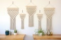 macrame wall hangings displayed in a row