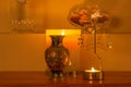 Abstract view of an interior candle lit shelf containing a spinning mobile with musical notes