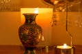 Abstract view of an interior candle lit shelf containing a spinning mobile with musical notes Royalty Free Stock Photo