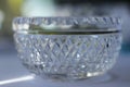 Macro abstract background of a beautiful diamond faceted lead crystal glass bowl with defocused background Royalty Free Stock Photo