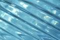 Macro abstract background of beautiful diagonal cut lead crystal glass texture reflecting light blue color