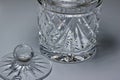 Macro abstract background of a beautiful vintage hand-cut lead crystal glass jar and lid with diamond shape cuts Royalty Free Stock Photo