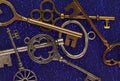 Macro of assorted vintage gold and silver keys on blue background