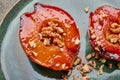 Macro baked quince with honey, walnut and cinnamon on green plate