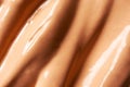 Macro BB cream or CC cream luxury smear texture background with selective focus. Beige liquid shiny creamy foundation backdrop