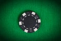 Macro black poker chip on green table Royalty Free Stock Photo
