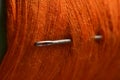 sewing needle on orange bobbin thread. Royalty Free Stock Photo