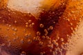 Macro of bubbles and fizz. A cool glass of cola drink with ice Royalty Free Stock Photo