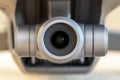 Macro close-up of a 3 axis electronic stabilized digital camera gimbal mounted on a modern remote controlled quadcopter drone.