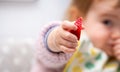 Macro Close up of Baby Hand with a Piece of Fruits Sitting in Child`s Chair Kid Eating Healthy Food Royalty Free Stock Photo