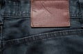 Macro, Close-up of blank leather label on new denim black jeans trousers. fashion and retro stlye Royalty Free Stock Photo