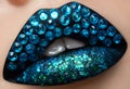 Macro and close-up creative make-up theme: beautiful female lips with black lipstick, blue diamonds and sequins, retouched photo Royalty Free Stock Photo