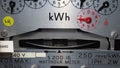 Macro close-up of a domestic kWh electric meter and dial.