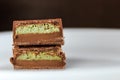 macro close-up of dubai chocolate with pistachio center halved and stacked Royalty Free Stock Photo