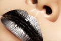 Macro close-up of female mouth. black Gloss Lips with silver glitter Makeup. Halloween Style Make-up. Dark Lipstick Royalty Free Stock Photo