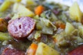 Macro close up of german hearty pea stew with potatoes, leek, carrots and smoked sausages - Germany