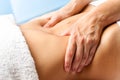 Macro close up of hands massaging female abdomen. Royalty Free Stock Photo