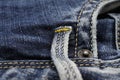 Macro close up of isolated blue casual denim jeans pants pocket with yellow stitches focus on belt loop Royalty Free Stock Photo