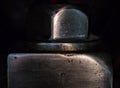 Macro close up of a machined steel bold joining two pieces of shiny metal together on a black background