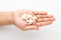 Macro Close up of medicinal or herbal light yellow tablet on female hand palm. Top view, Royalty Free Stock Photo