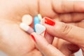 Macro Close up of medicinal or herbal  multi color tablet, capsule and pill on a female hand palm. Royalty Free Stock Photo