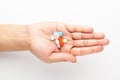 Macro Close up of medicinal or herbal  multi color tablet, capsule and pill on a female hand palm. Royalty Free Stock Photo