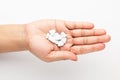 Macro Close up of medicinal or herbal white color  pill on a female hand palm. Royalty Free Stock Photo