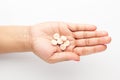 Macro Close up of medicinal or herbal white pill on female hand palm. Top view, Royalty Free Stock Photo