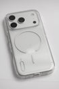 Close-up of new iPhone 17 Pro with transparent MagSafe case on white background, sleek modern smartphone technology design Royalty Free Stock Photo