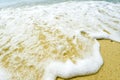 Macro close up of ocean sea water rushing in to sandy beach shore Royalty Free Stock Photo