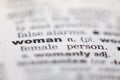 Macro close up of old English dictionary page with word woman Royalty Free Stock Photo