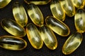 Macro Close up of Omega 3 gel capsule on a reflective black background Royalty Free Stock Photo