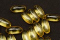 Macro Close up of Omega 3 gel capsule on a reflective black background Royalty Free Stock Photo