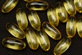 Macro Close up of Omega 3 gel capsule on a reflective black background Royalty Free Stock Photo