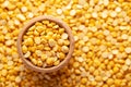 Macro Close-up of Organic Bengal Gram Cicer arietinum or split yellow chana dal in an earthen clay pot kulhar