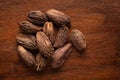 Macro close-up of Organic Black cardamom Amomum subulatum on wooden top background. Pile of Indian Aromatic Spice.