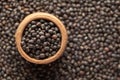 Macro Close up of Organic Black Gram Vigna mungo or whole black urad in an earthen clay pot kulhar on the self background