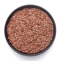 Macro Close up of Organic Brown flaxseeds Linum usitatissimum or linseed on a black ceramic bowl ,