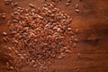 Macro Close up of Organic Brown flaxseeds Linum usitatissimum or linseed cleaned on wooden top background