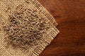 Macro close-up of Organic cumin seed Cuminum cyminum or jeera on the wooden top background and jute mat. Royalty Free Stock Photo