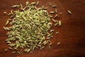 Macro close-up of Organic Fennel Seeds Foeniculum vulgare Badi sonf on wooden top background. Pile of Indian Aromatic Spice.