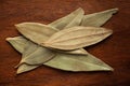 Macro close-up of Organic Indian bay leaf Cinnamomum tamala  tezpatta on wooden Top background. Pile of Indian Aromatic Spice. Royalty Free Stock Photo