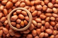 Macro Close-up of organic red-brown peanuts Arachis hypogaea  in an earthen clay pot kulhar on the self background. Royalty Free Stock Photo