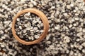 Macro Close up of Organic split black urad dal Vigna mungo with shell in an earthen clay pot kulhar on the self background.