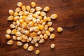 Macro Close up organic yellow corn seed or maize Zea mays cleaned on wooden top background